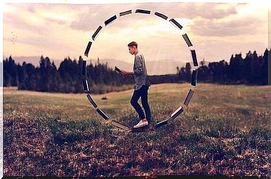 man reading book in circle of books