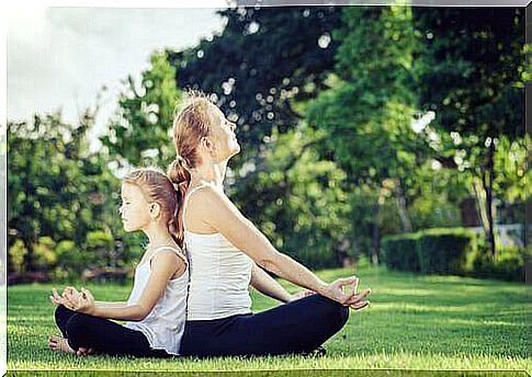 mother and daughter meditating