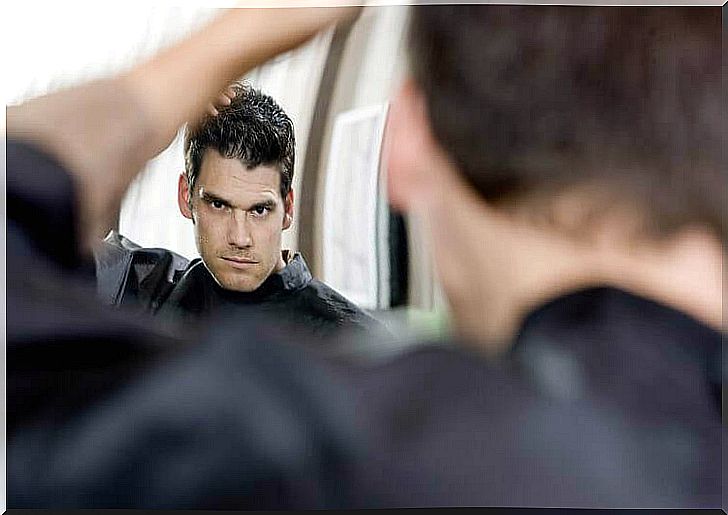 man looking at himself in the mirror