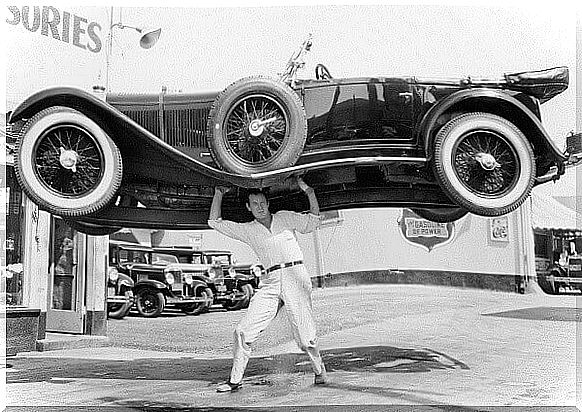 man lifting a car