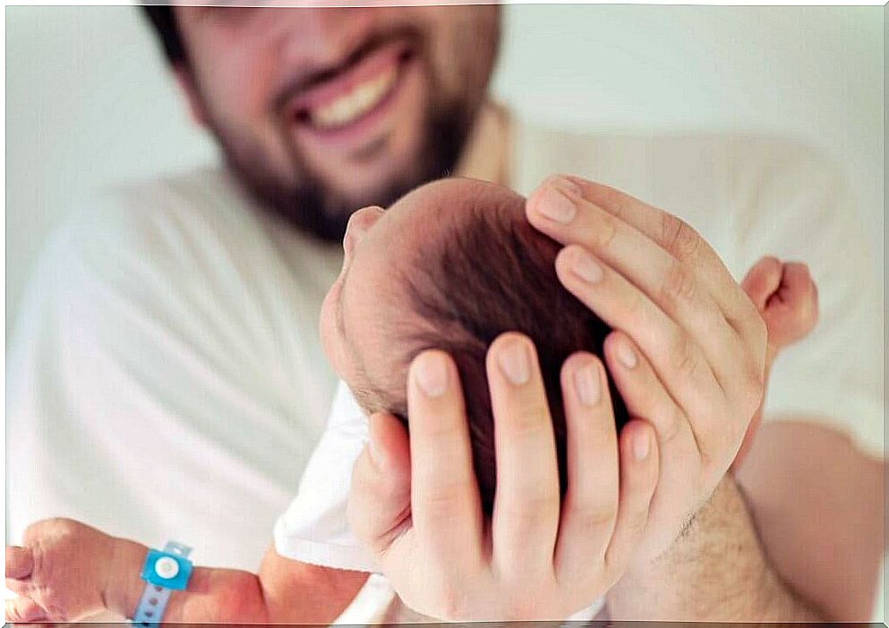 father holding newborn son