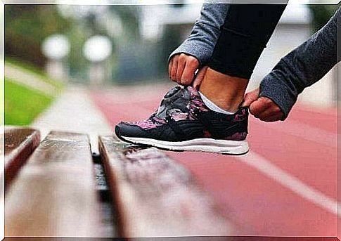 Woman putting on running shoes