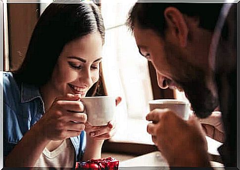 couple smiling drinking coffee