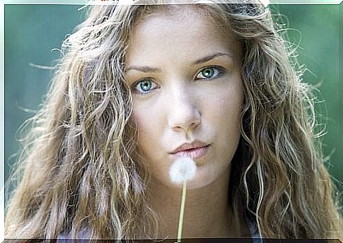 woman blowing dandelion